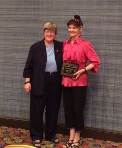 Dr. Marilyn Buck, associate Provost at Ball State University (left)  awards Mrs. LeAnn Haggard (right) with the Meritorious Service Award