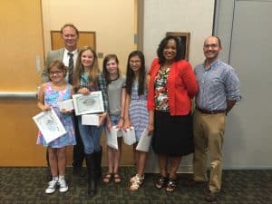 Students with Principal Pomerenke, teacher Steve Auslander, and Superintendent Dr. Woodson