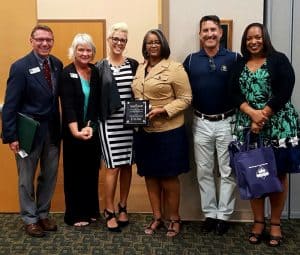 JELCC Director Shawn Wright-Browner, Supervisor of Community and Continuing Education Todd DeLey, and Superintendent Dr. Woodson with representatives from Ivy Tech